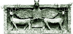 Stone relief depicting a winged creature with a lion’s head flanked by two deer, each holding one of the creature’s wings with their mouths. The scene is framed by a rectangular border.