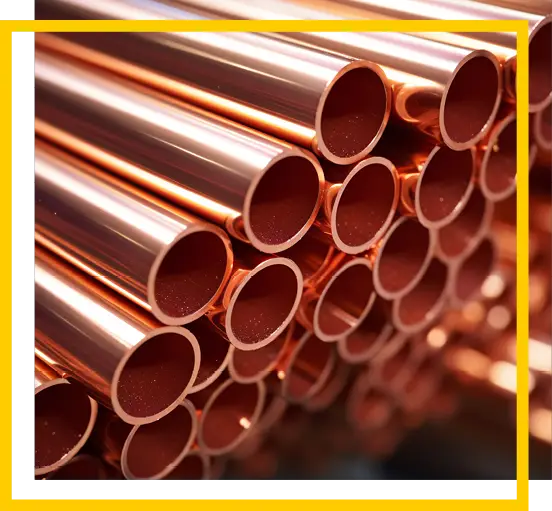 A close-up view of stacked shiny copper pipes arranged in parallel, with a yellow and white border framing the image.