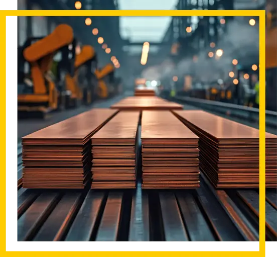 Stacks of copper sheets are neatly arranged on a conveyor belt inside a large, industrial factory with robotic arms and a hazy background, suggesting active manufacturing.